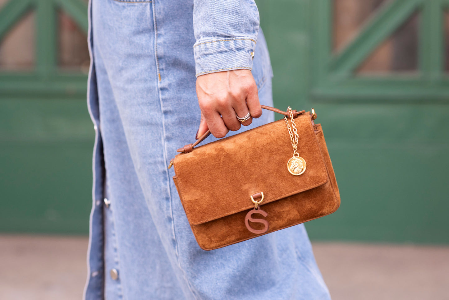 Model holding Aurora bag top handle close up