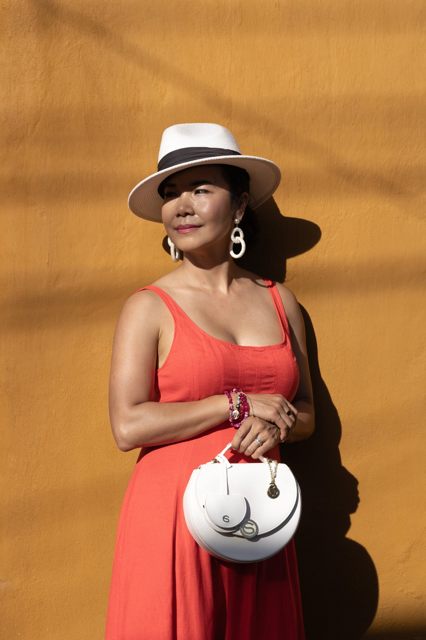 Model holding top handle of Chau Saenz Luxury Luna set with Charm 