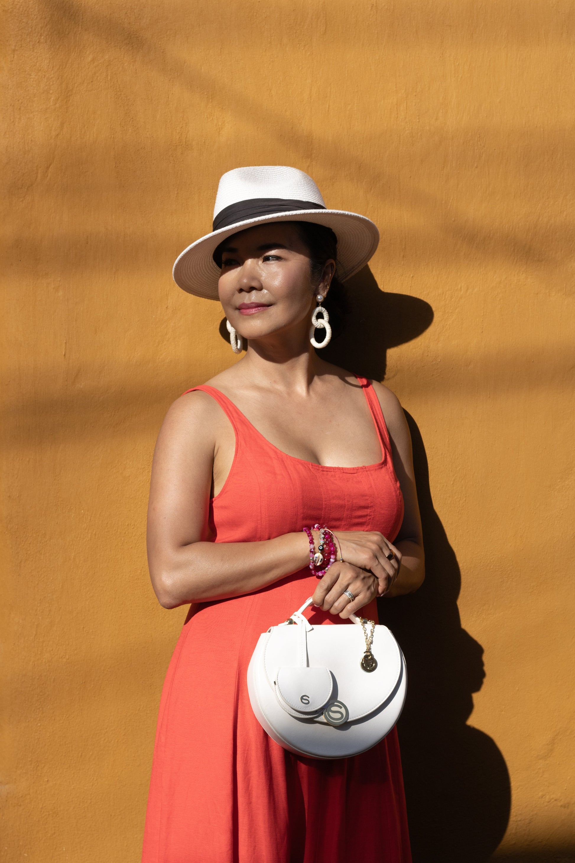 Model holding top handle of Chau Saenz Luxury Luna set with Charm 