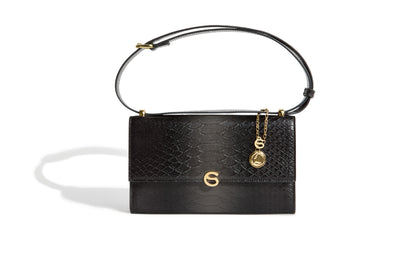 A limited edition grey handbag with a textured exterior, gold-tone hardware, and an adjustable shoulder strap.