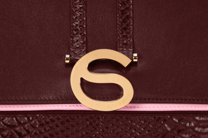 Gold hardware detail on Rose bag in Oxblood Italian leather.