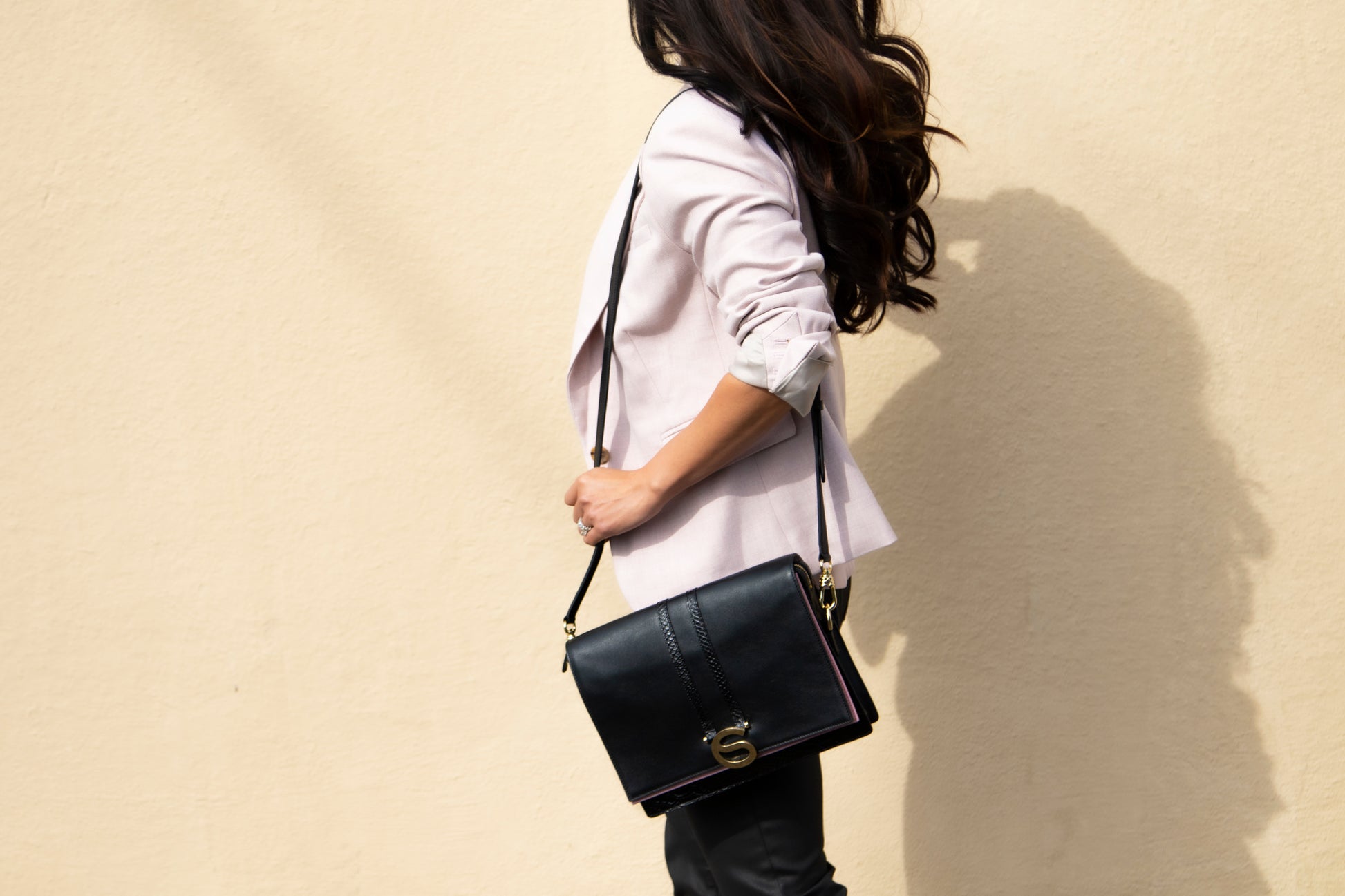 Rose bag in Nero Italian leather worn crossbody.